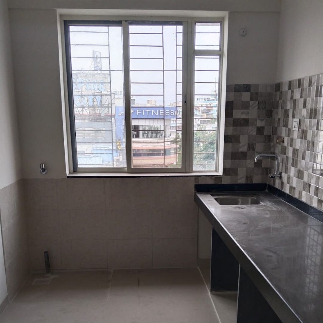 Modern modular kitchen in a ready possession 2 BHK flat at Spine Road, Moshi